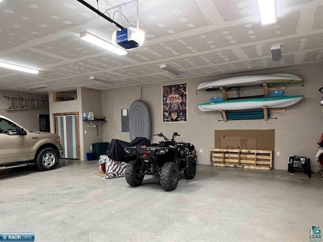 garage with electric panel and a garage door opener