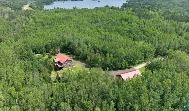 aerial view with a water view and a wooded view