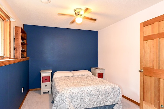 carpeted bedroom with a textured ceiling and ceiling fan