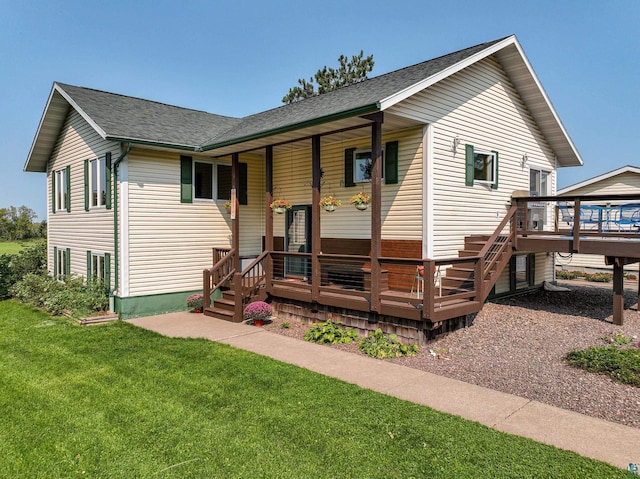 view of front of home featuring a front yard and a deck