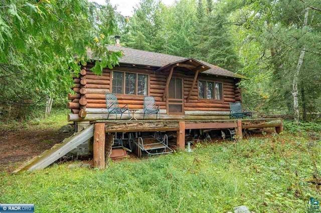 rear view of property featuring a deck