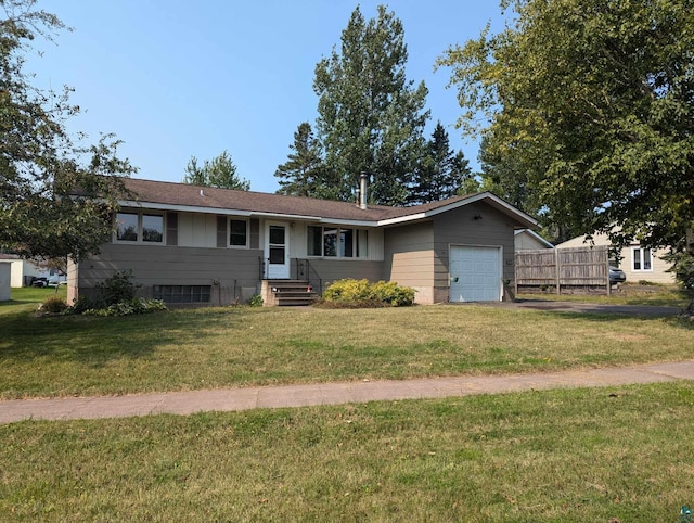 ranch-style house featuring a garage and a front lawn