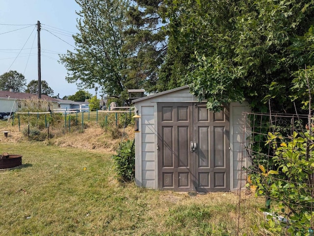 view of outbuilding with a yard