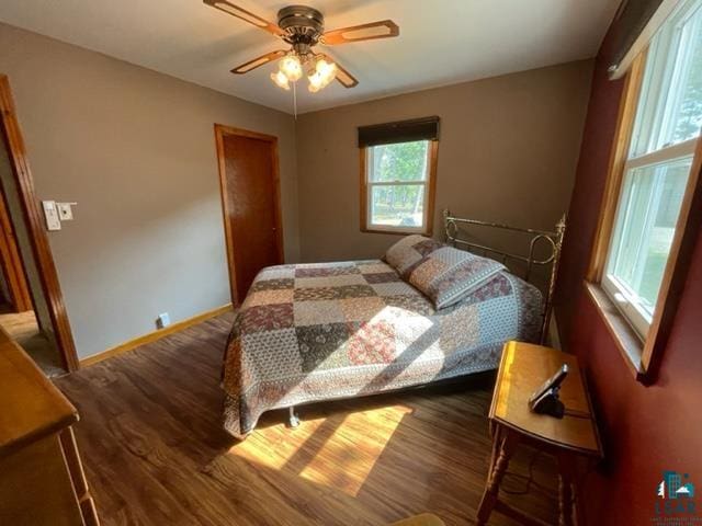 bedroom with ceiling fan and dark hardwood / wood-style floors