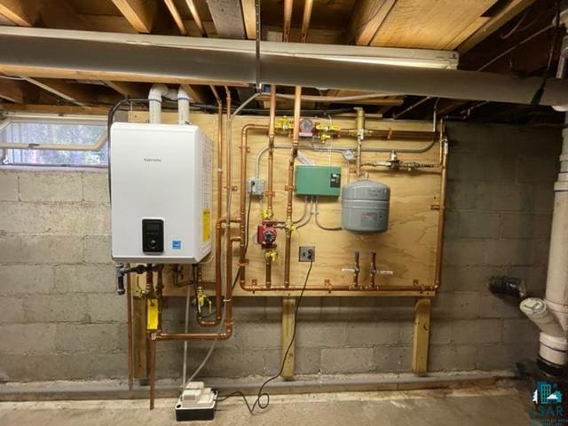 utility room featuring tankless water heater