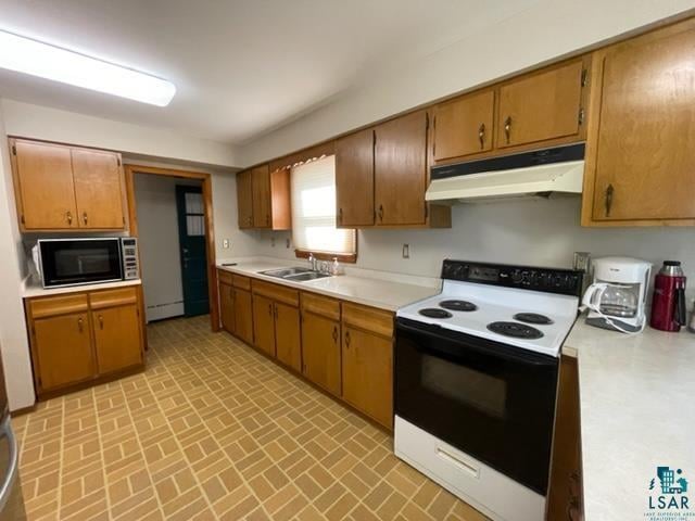 kitchen with a baseboard radiator, electric range, and sink