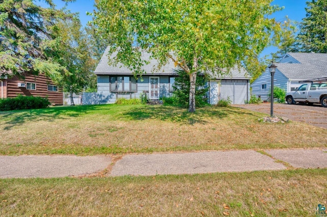 view of front of property featuring a garage and a front lawn