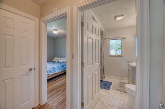 bathroom with wood-type flooring, toilet, and vanity