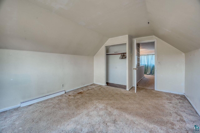 additional living space featuring light carpet, lofted ceiling, and a baseboard radiator