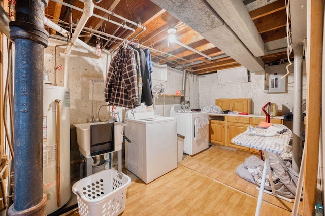 laundry room featuring gas water heater, cabinets, separate washer and dryer, sink, and light wood-type flooring