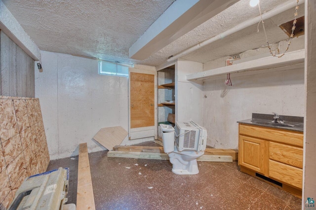 basement with a textured ceiling and sink