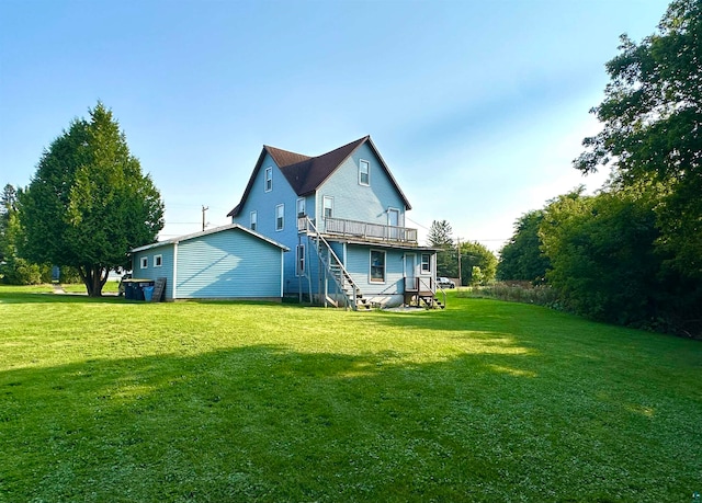 back of property with a yard and a wooden deck