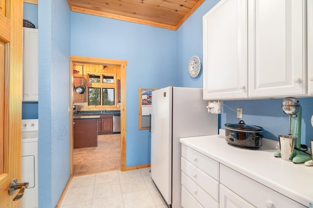 kitchen with dishwasher, wood ceiling, washer / clothes dryer, white cabinets, and light tile patterned flooring