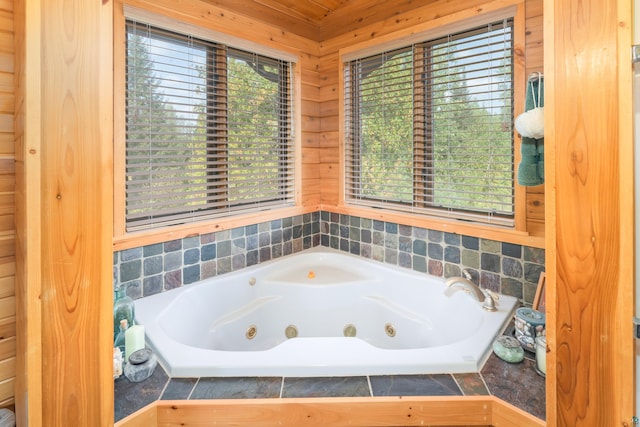 bathroom with a wealth of natural light and tiled bath