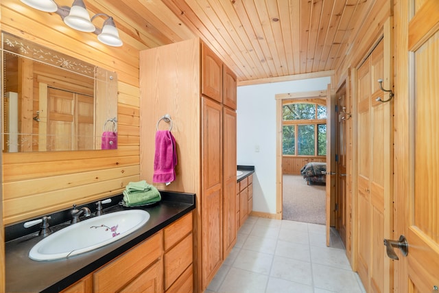 bathroom featuring tile patterned flooring, wooden ceiling, and vanity