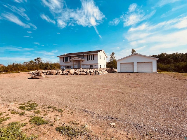 view of front of property featuring an outdoor structure and a garage