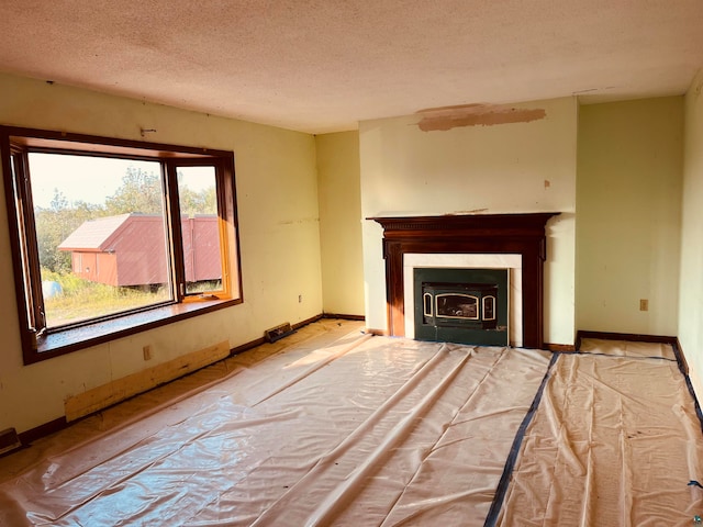 unfurnished living room featuring a textured ceiling