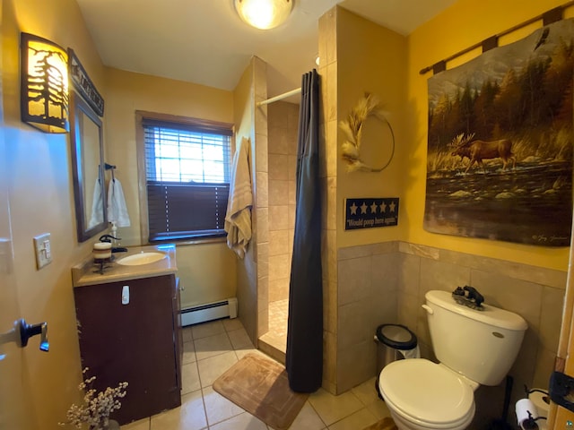 bathroom featuring tile walls, vanity, walk in shower, toilet, and a baseboard heating unit