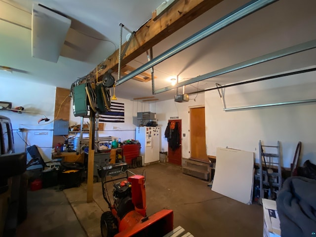 garage with a garage door opener and white fridge