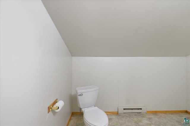 bathroom with vaulted ceiling, a baseboard radiator, and toilet