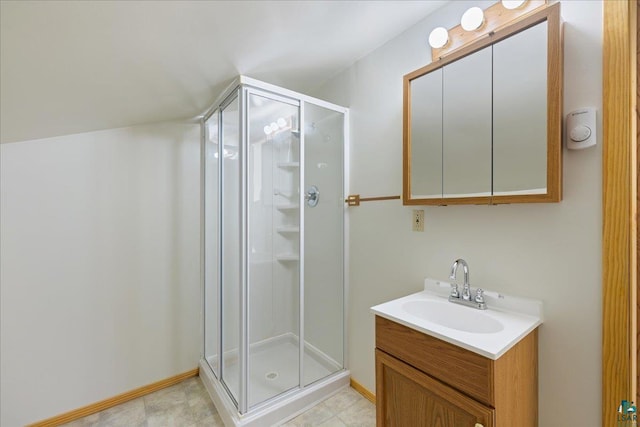 bathroom featuring vanity and an enclosed shower