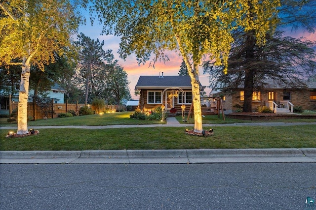 bungalow-style home with a yard