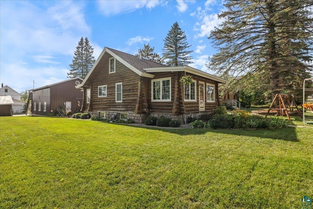 view of side of home featuring a playground and a yard