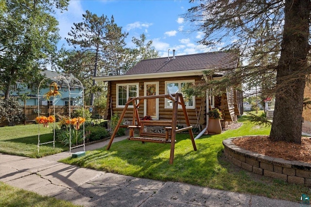 view of front of house featuring a front yard and a playground