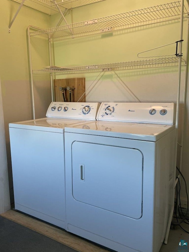 washroom with independent washer and dryer