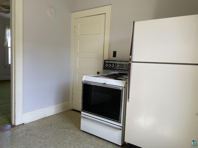 kitchen with white appliances and light carpet