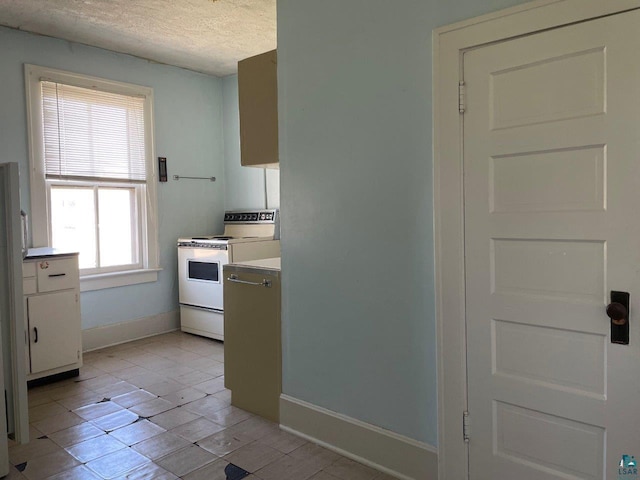 kitchen with white range, a textured ceiling, white cabinetry, and light tile patterned flooring