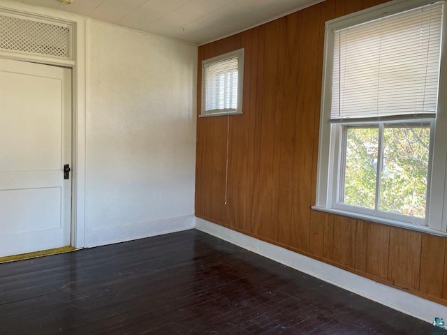 interior space with wood walls and dark hardwood / wood-style floors