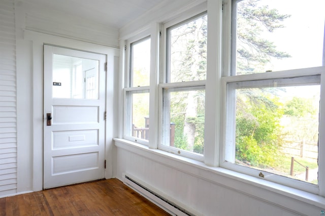 unfurnished sunroom with a wealth of natural light and a baseboard radiator