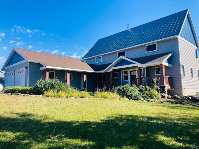 view of front of house featuring a garage, covered porch, and a front lawn