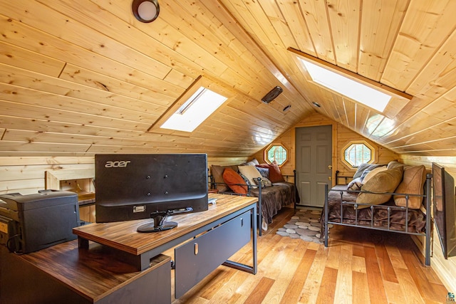 office space featuring vaulted ceiling with skylight, wood ceiling, wood walls, and light hardwood / wood-style flooring