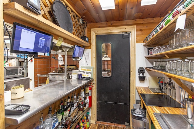 kitchen featuring stainless steel counters and wooden ceiling