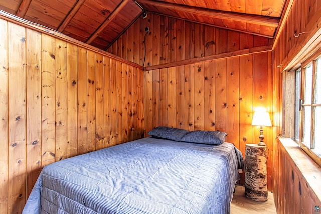 bedroom featuring vaulted ceiling with beams, wooden walls, light wood-type flooring, and wooden ceiling