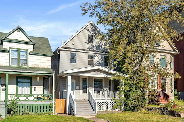 view of front of home with a front yard and a porch