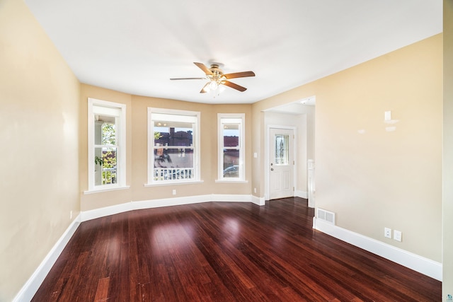 unfurnished room with dark wood-type flooring and ceiling fan