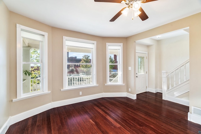 foyer entrance featuring ceiling fan and dark wood-type flooring