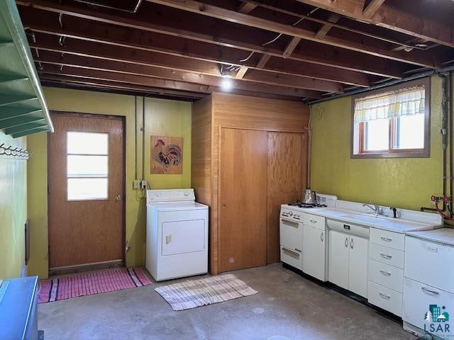 washroom featuring a healthy amount of sunlight, sink, and washer / dryer