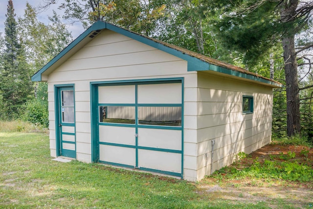 view of outbuilding featuring a lawn