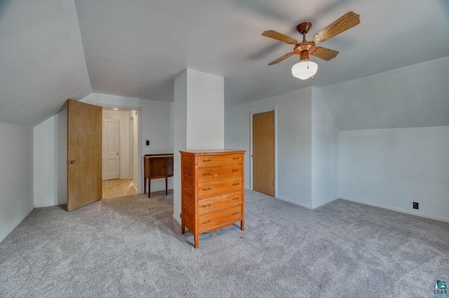 additional living space with lofted ceiling, ceiling fan, and light colored carpet