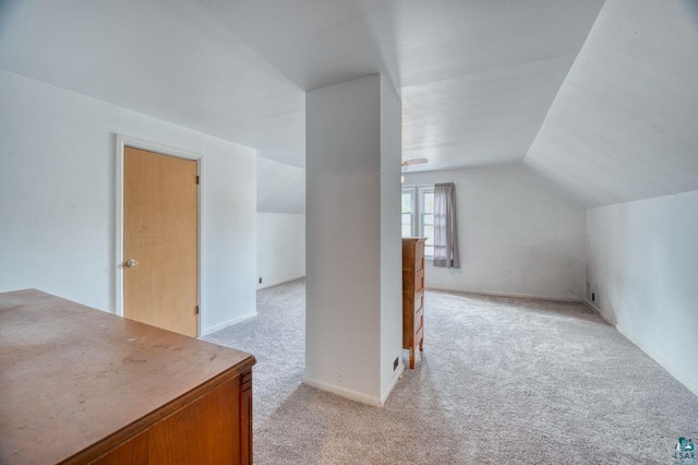 bonus room featuring lofted ceiling and light colored carpet