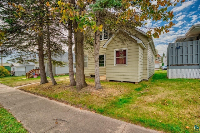 view of property exterior featuring a lawn