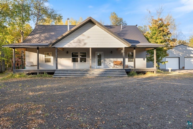 view of front of property with an outbuilding, a porch, and a garage