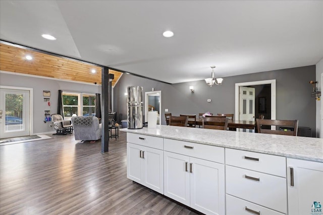 kitchen with pendant lighting, a notable chandelier, white cabinetry, light hardwood / wood-style flooring, and light stone countertops