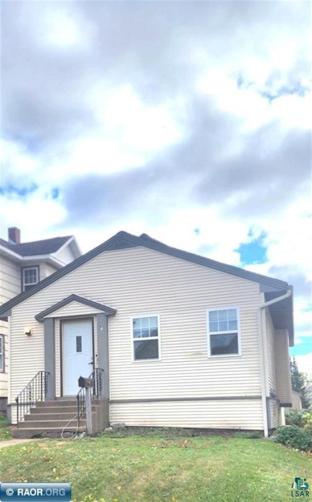 rear view of house with a lawn