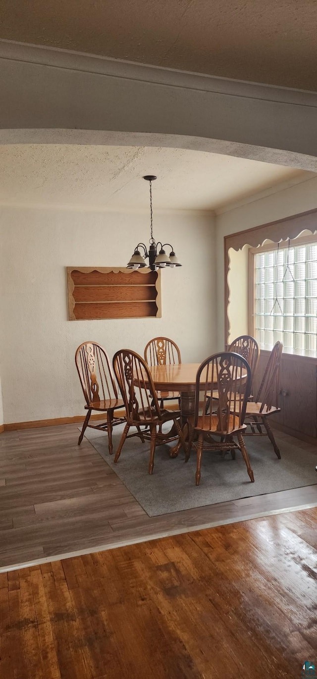 dining room with hardwood / wood-style floors, a chandelier, and a textured ceiling