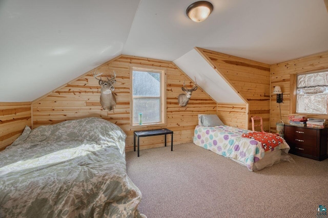 carpeted bedroom featuring lofted ceiling and wooden walls